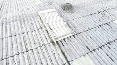 Image highlighting the weathered state of the asbestos roof.