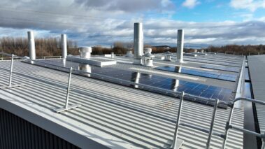 Aerial view of the building showcasing the expansive metal profiled roof and solar PV system