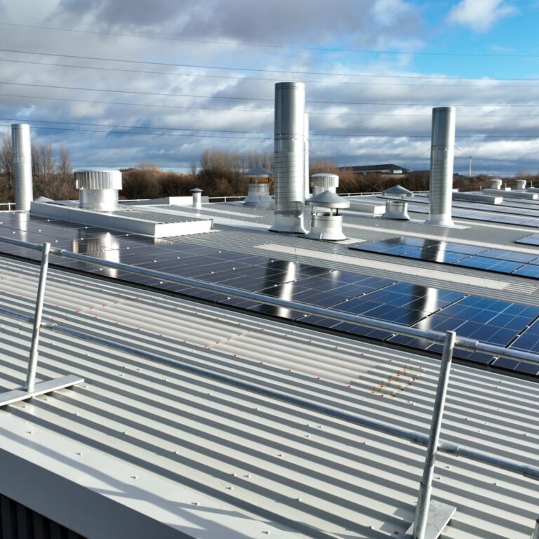 Aerial view of the building showcasing the expansive metal profiled roof and solar PV system