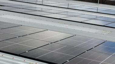 Wide shot of the building showcasing the visual appeal of the new metal profiled roof and solar PV system