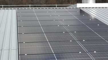 Close-up of the solar PV system's panels on the metal profiled roof.
