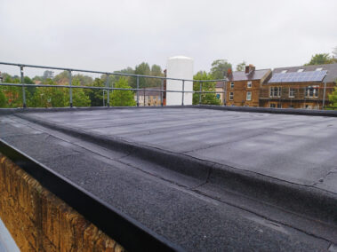 A shot capturing a section of the roof post-rain, highlighting the water repellency and effectiveness of the new roofing system.