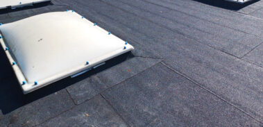 A perspective shot capturing the shadows cast by the roof fixtures in the evening sun, adding depth and dimension to the roof's features.