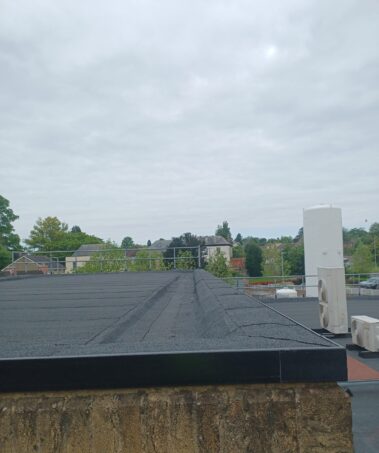 A shot capturing the detailed work around the roof lights and penetrations, showcasing the meticulous detailing ensuring system integrity.