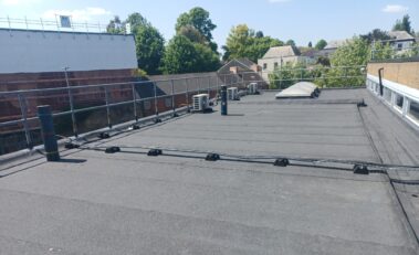 Image focusing on the area where the liquid coating solution was applied, highlighting its smooth finish and integration with the surrounding roof.