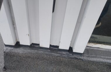 Detailed shot of the edge detailing where the roof meets the building's facade, highlighting the precision and quality of the finish.