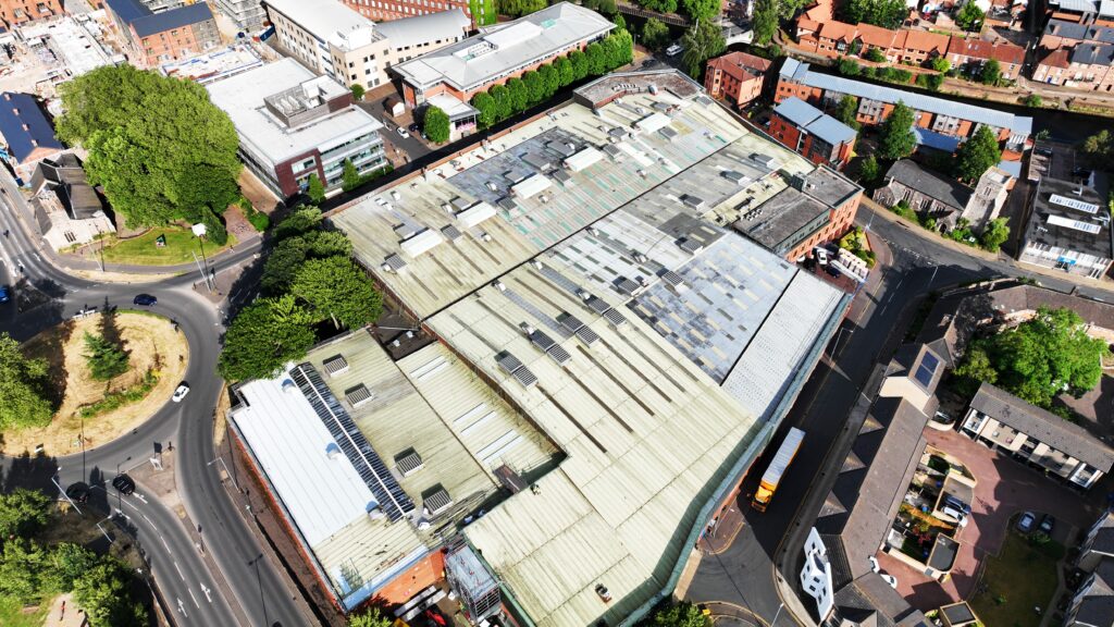 Aerial view of Norwich industrial area before a project, with roads, buildings, and greenery.