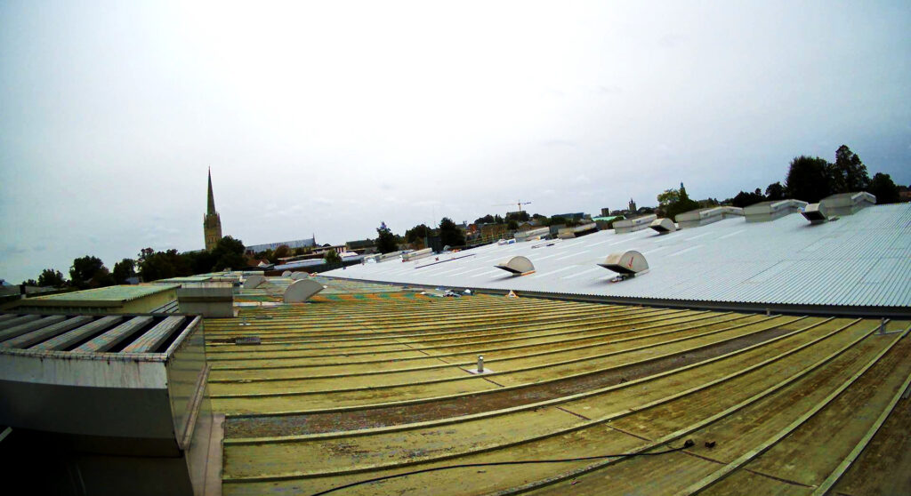 Industrial roof in Norwich with church spire in the background.