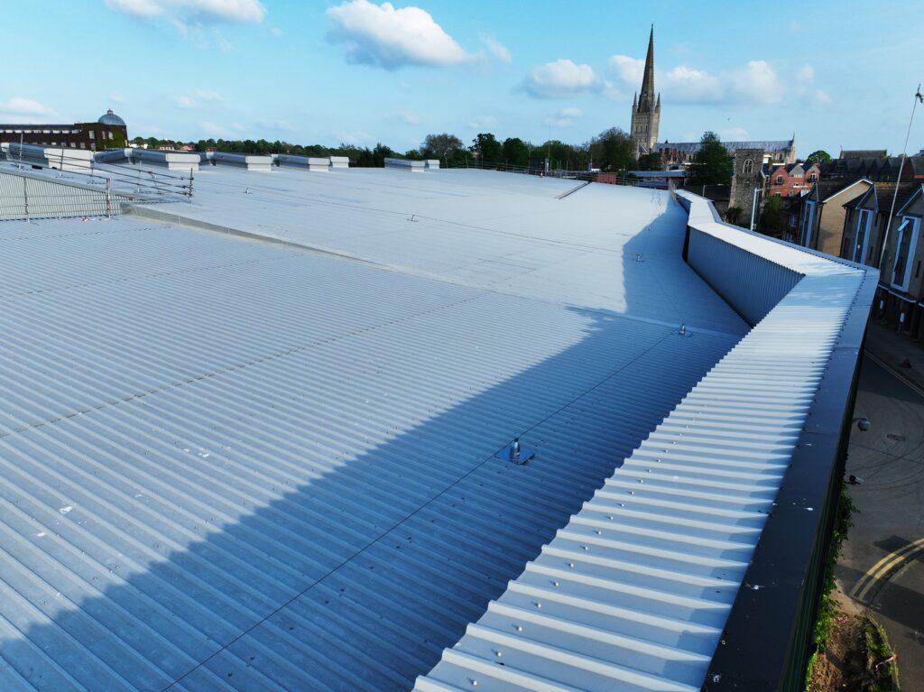 Industrial roof with a view of the church spire in Norwich.