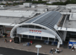 Refurbished glazed atrium and storefront at Tesco Bury with modern glass panels and new signage installed by Weatherproofing Advisors.